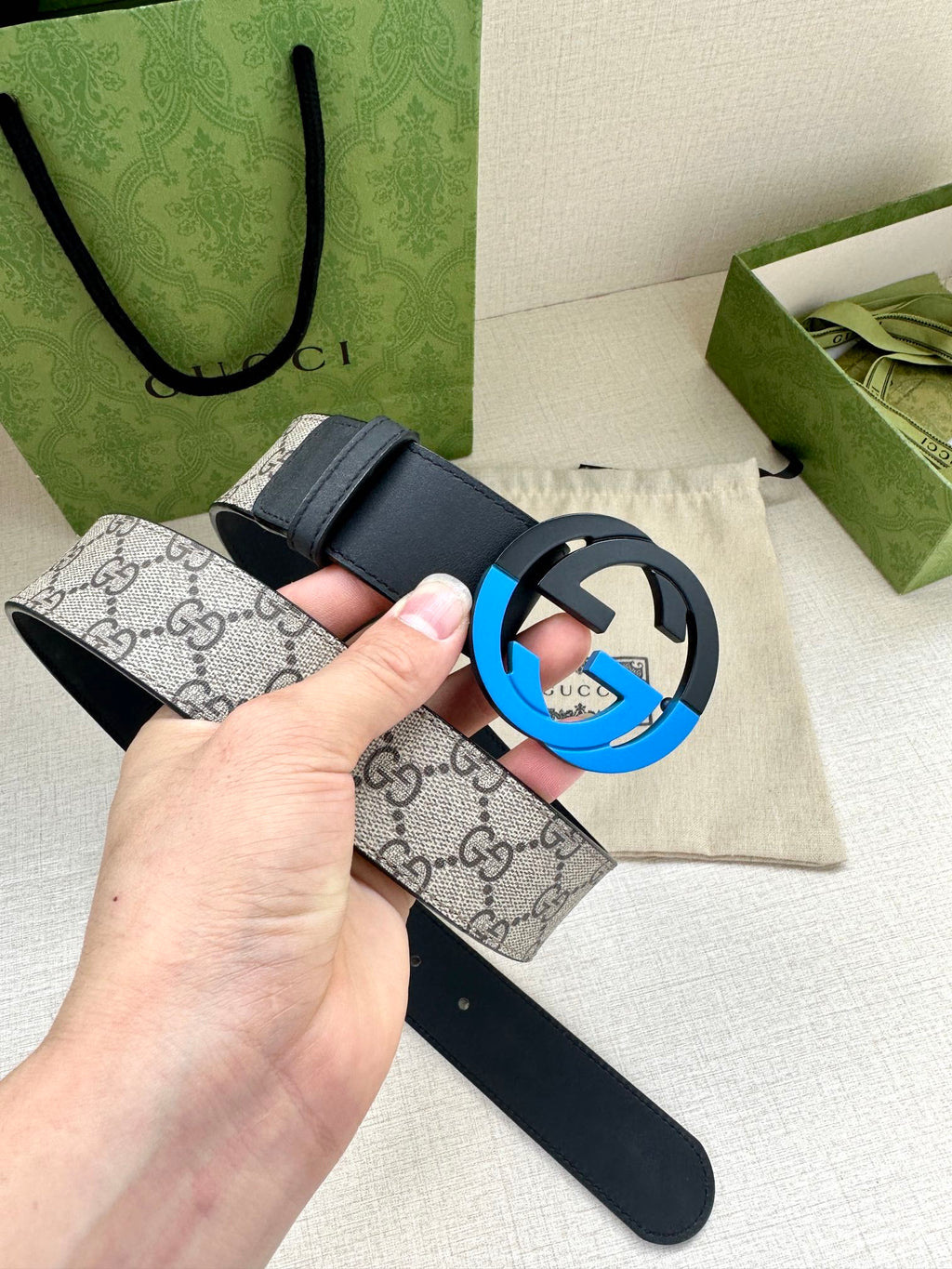 Designer belt with dark blue leather and light GG canvas strap, blue-accent GG buckle