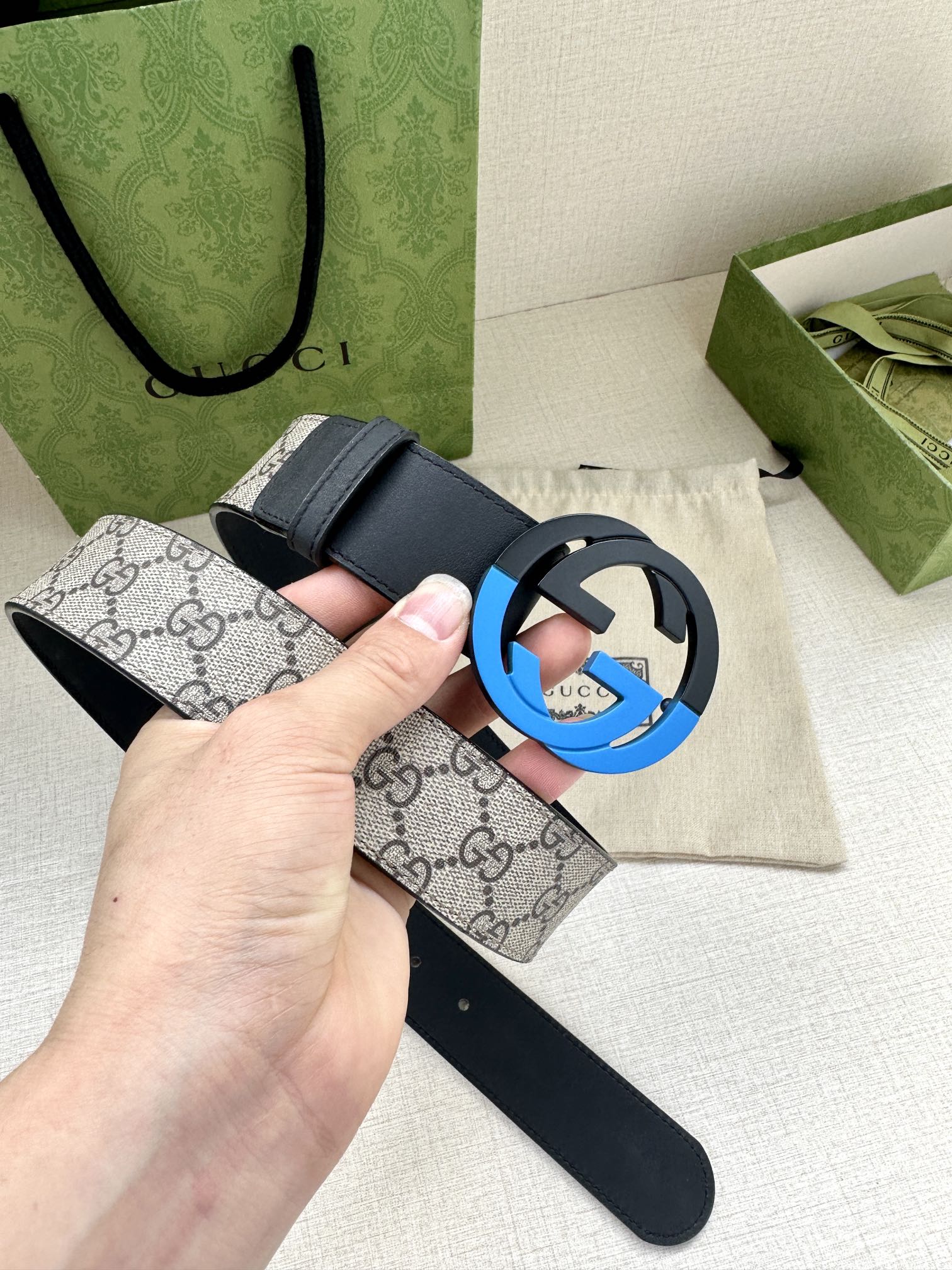 Designer belt with dark blue leather and light GG canvas strap, blue-accent GG buckle