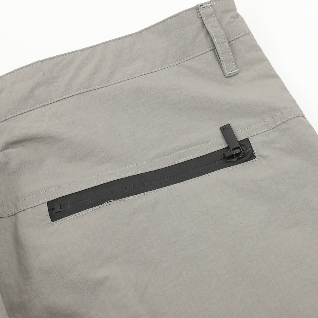 Dior pants, light gray side view with black zip insert and belt loop