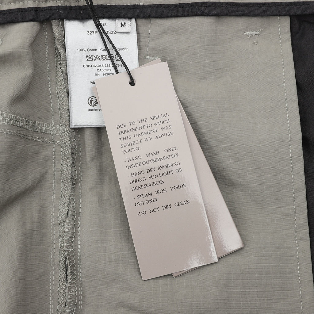 Dior pants, interior care tag and size label on light gray fabric