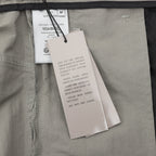 Dior pants, interior care tag and size label on light gray fabric