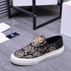 Versace slip-on sneaker, dark patterned upper with gold embellishment and white low-profile sole