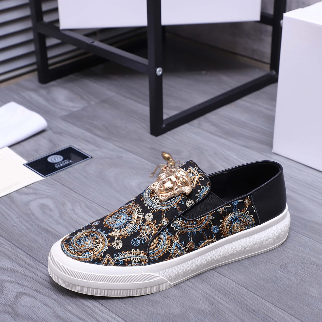 Versace slip-on sneaker, dark patterned upper with gold embellishment and white low-profile sole