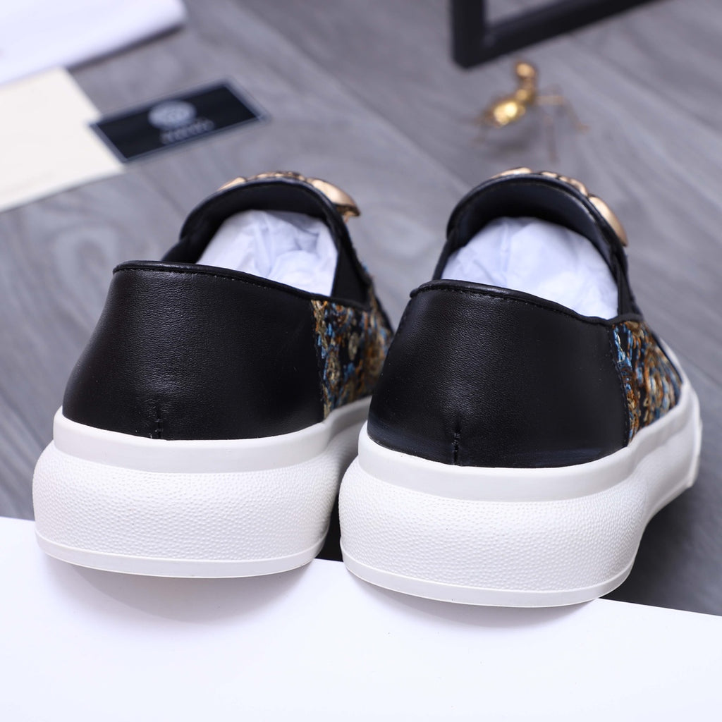 Versace slip-on sneaker back view, black heel with dark patterned side panel and white sole
