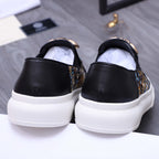 Versace slip-on sneaker back view, black heel with dark patterned side panel and white sole