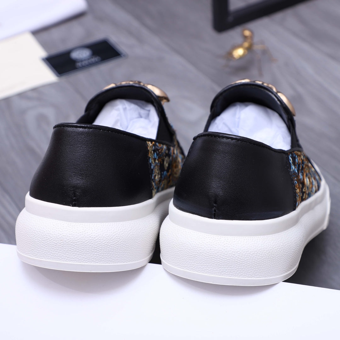 Versace slip-on sneaker back view, black heel with dark patterned side panel and white sole