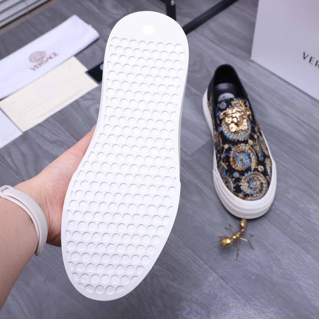 Versace slip-on sneaker outsole view, white rubber tread sole with patterned upper