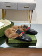Gucci black slip-on sandals with plush fur lining and green-red web GG buckle
