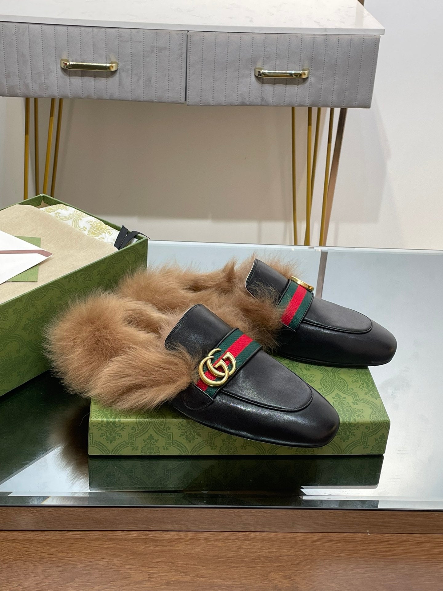 Gucci black slip-on sandals with plush fur lining and green-red web GG buckle