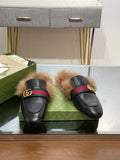 Gucci black fur slides with green-red web strap and gold GG buckle details