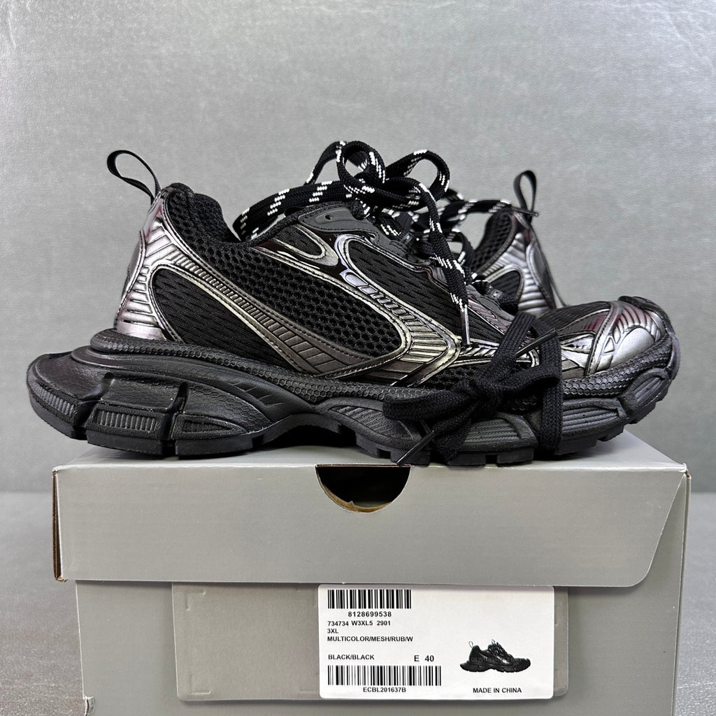 Black and silver Balenciaga sneakers on box, chunky sole, black mesh and metallic trim