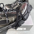 Close-up of black and silver Balenciaga sneakers with laces and metal accent detailing