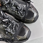 Close-up of black and silver Balenciaga sneakers upper with laces and side stripe detail