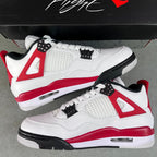 Air Jordan 4 sneakers pair, white leather with red midsole and black outsole