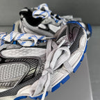 Balenciaga unisex sneaker close-up, textured panels, white laces, blue tread sole