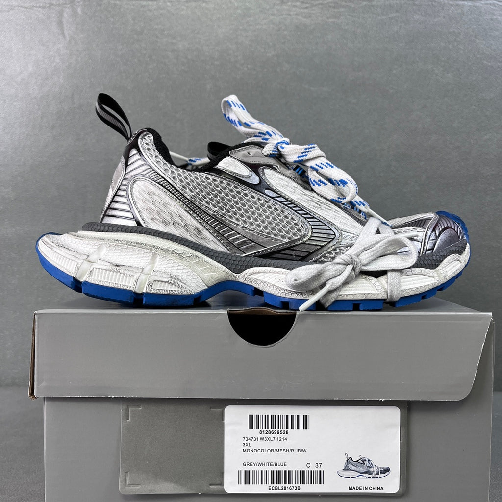 Balenciaga unisex sneakers on box, gray and black uppers with blue sole accents