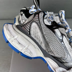Balenciaga unisex sneakers side view, gray leather-look overlays with blue-edged soles