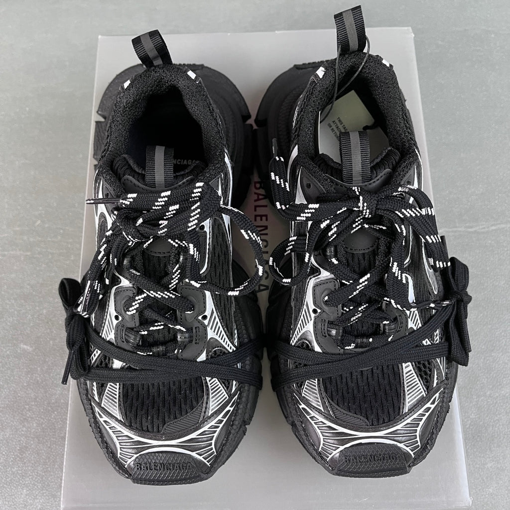 Balenciaga unisex sneakers rear view, black with white accents, lace-up, padded collar