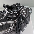Balenciaga unisex sneakers close-up, black laces, white side panel, textured upper