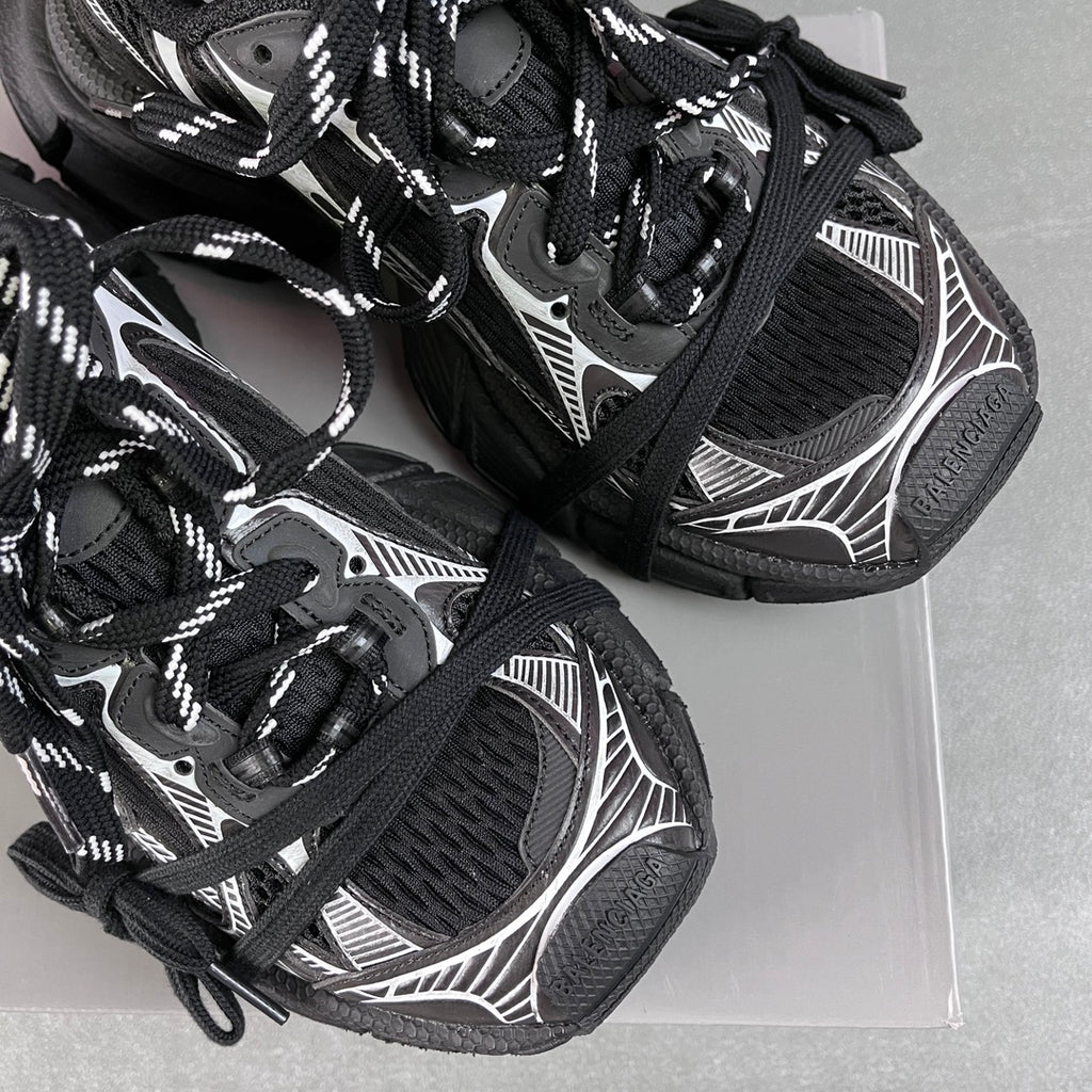 Balenciaga unisex sneakers detail, black mesh texture, white graphics, lace-up