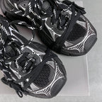 Balenciaga unisex sneakers detail, black mesh texture, white graphics, lace-up
