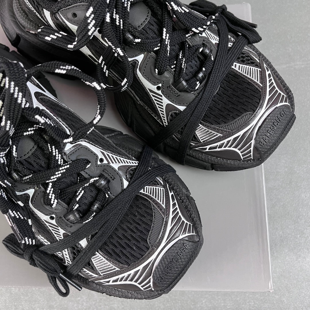 Balenciaga unisex sneakers detail, black mesh texture, white graphics, lace-up