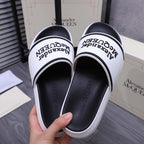 Alexander McQUEEN slide sandals, view of white outer soles and black footbed