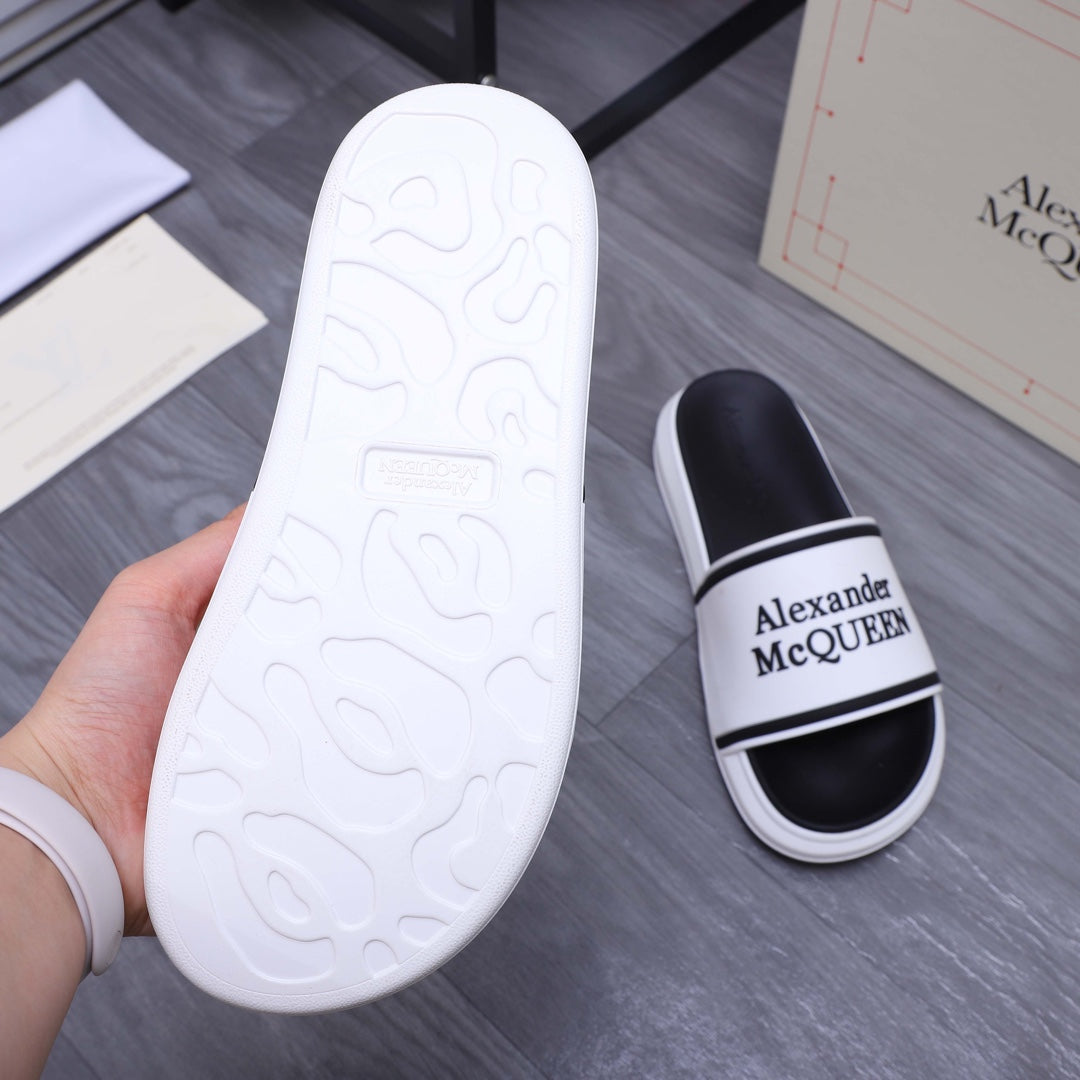 Alexander McQUEEN slide sandal outsole, white textured sole with black slide beside