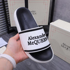 Alexander McQUEEN slide sandal close-up, white band with black logo on strap