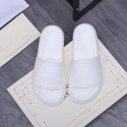 Alexander McQueen white slide sandals with wide padded strap and embossed logo