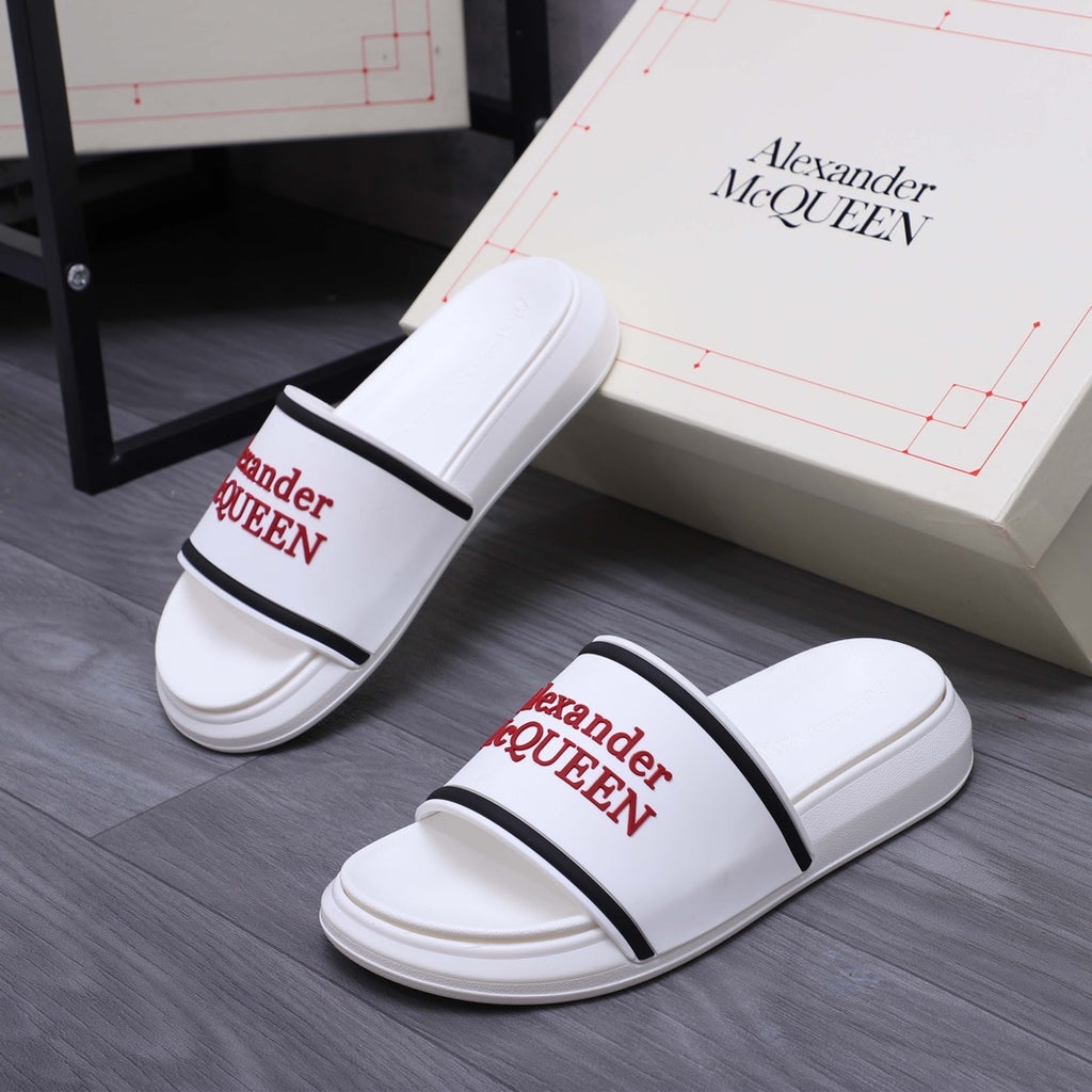 Pair of white slide sandals with black strap band and red Alexander McQUEEN logos