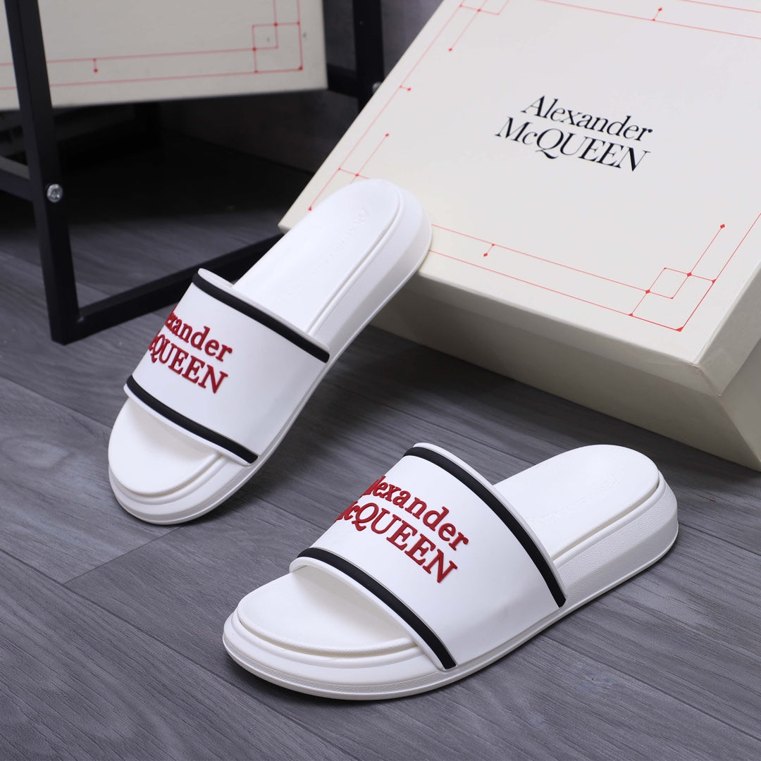 Pair of white slide sandals with black strap band and red Alexander McQUEEN logos