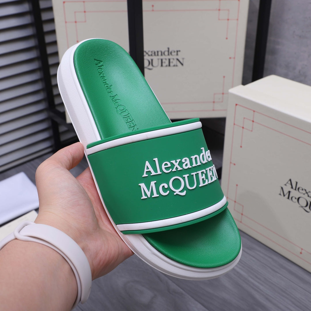 Green slide sandal in hand with Alexander McQUEEN logo on the wide strap