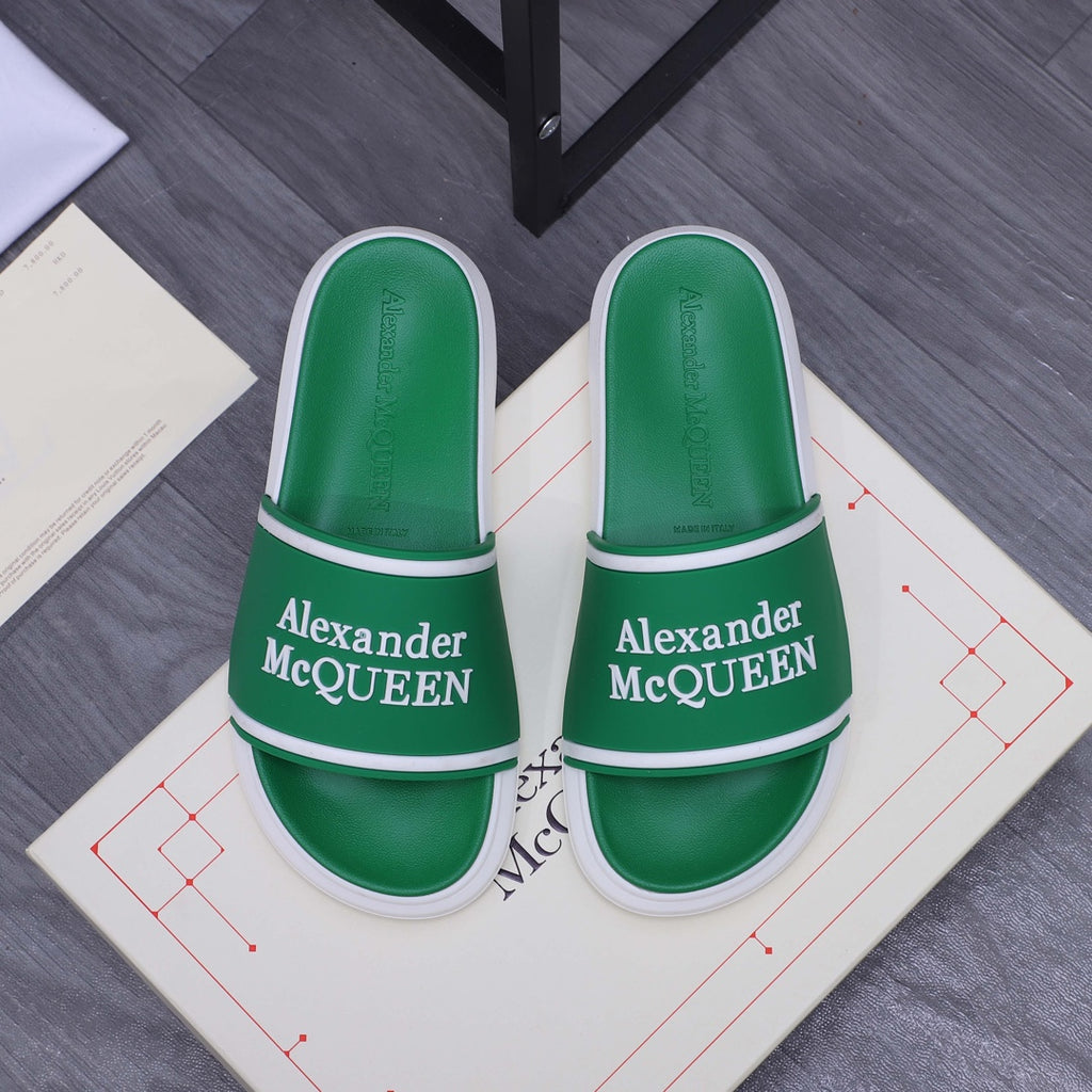 Green slide sandals with white trim and Alexander McQUEEN logo on the strap