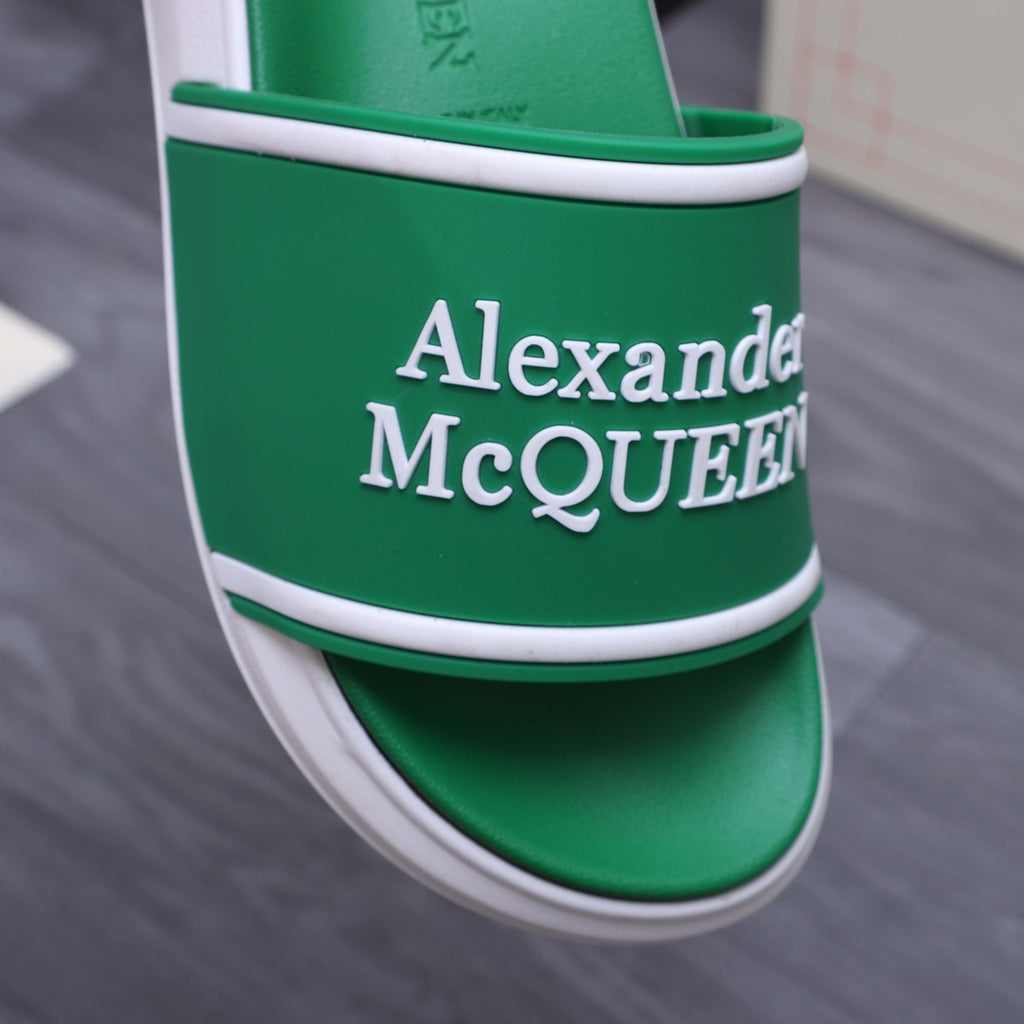 Green slide sandal strap detail with Alexander McQUEEN logo and white trim