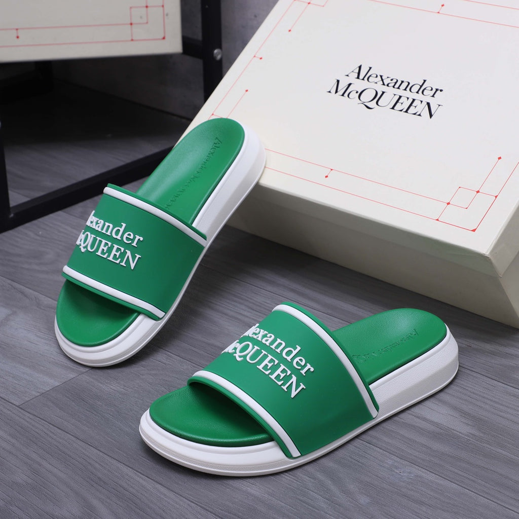 Green slide sandals with white soles and Alexander McQUEEN logo on the strap