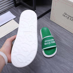 White textured outsole on a green slide sandal with Alexander McQUEEN logo