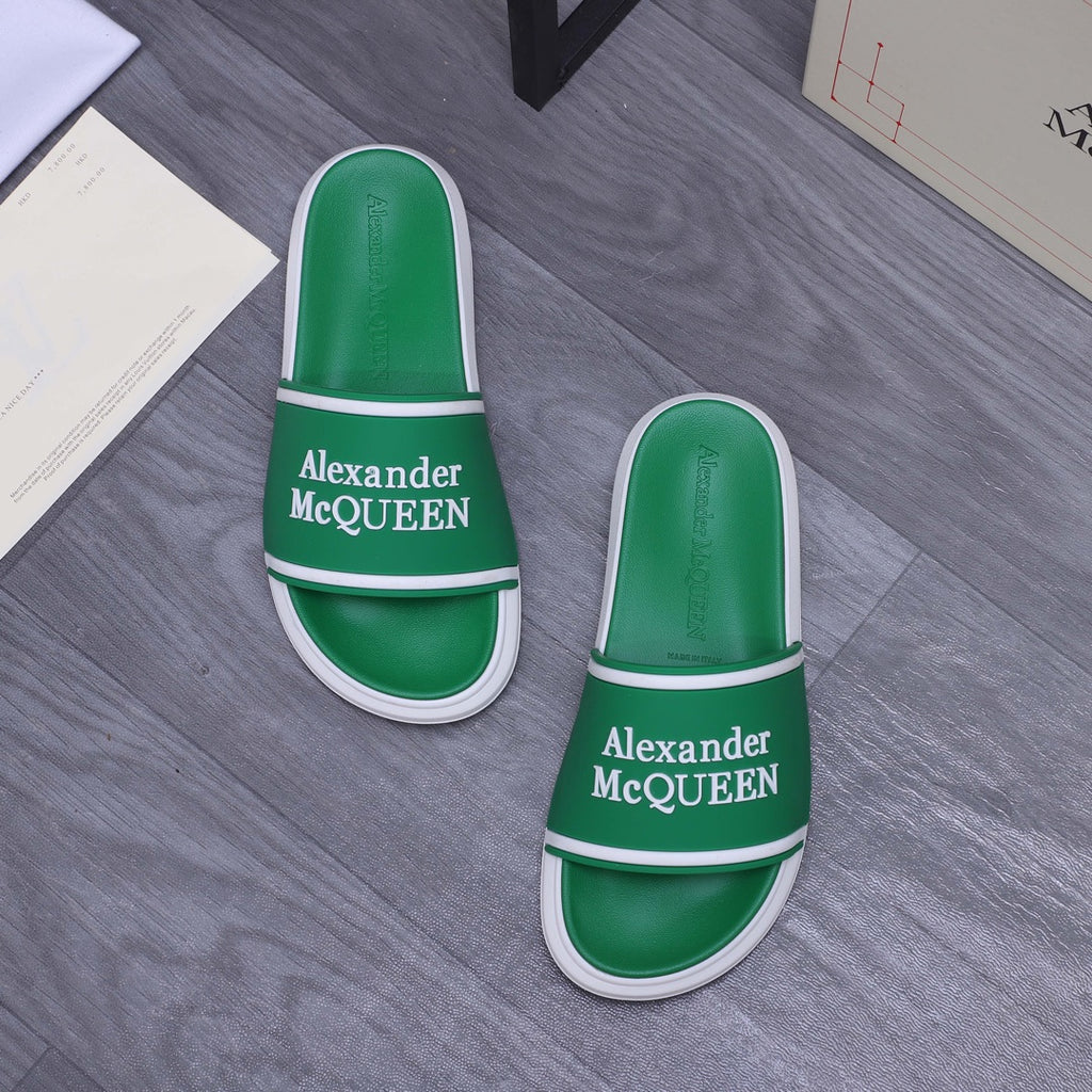 Green slide sandals with white edges and Alexander McQUEEN logo on the strap