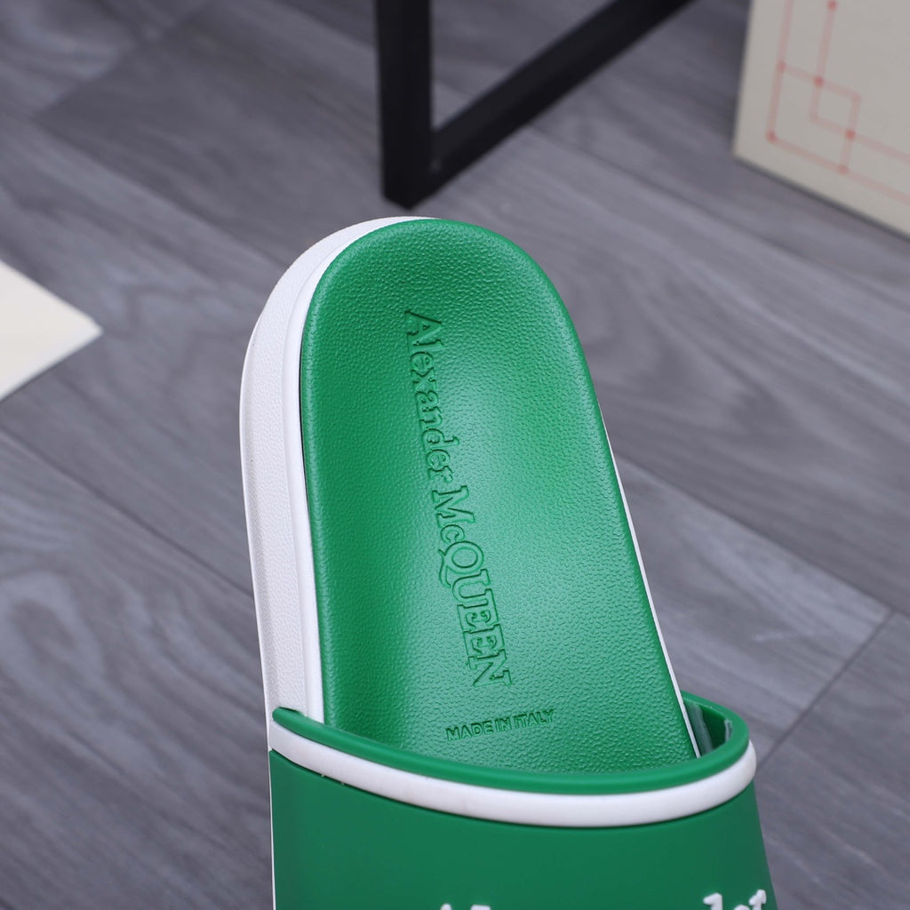Green slide sandal footbed with embossed Alexander McQUEEN text and white edge
