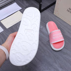 White rubber outsole of pink slide sandal with embossed Alexander McQueen text