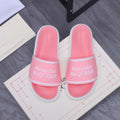 Pink slide sandals with wide strap and Alexander McQueen logo, white sole