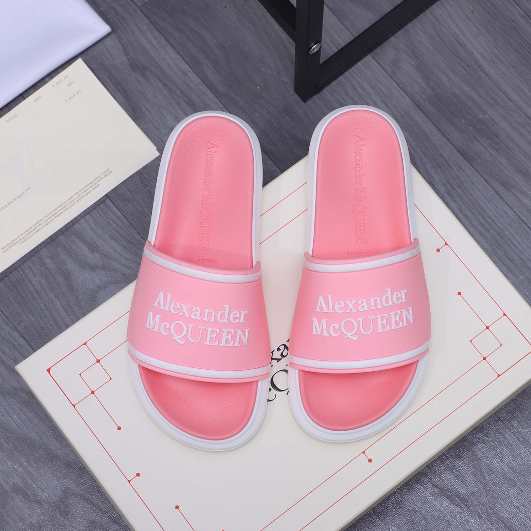 Pink slide sandals with wide strap and Alexander McQueen logo, white sole