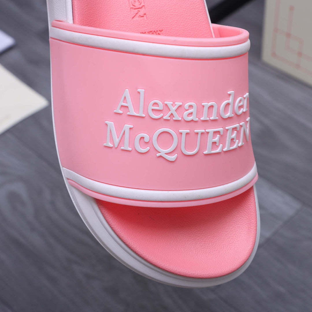 Pink slide sandal close-up of side strap with Alexander McQueen name, white trim