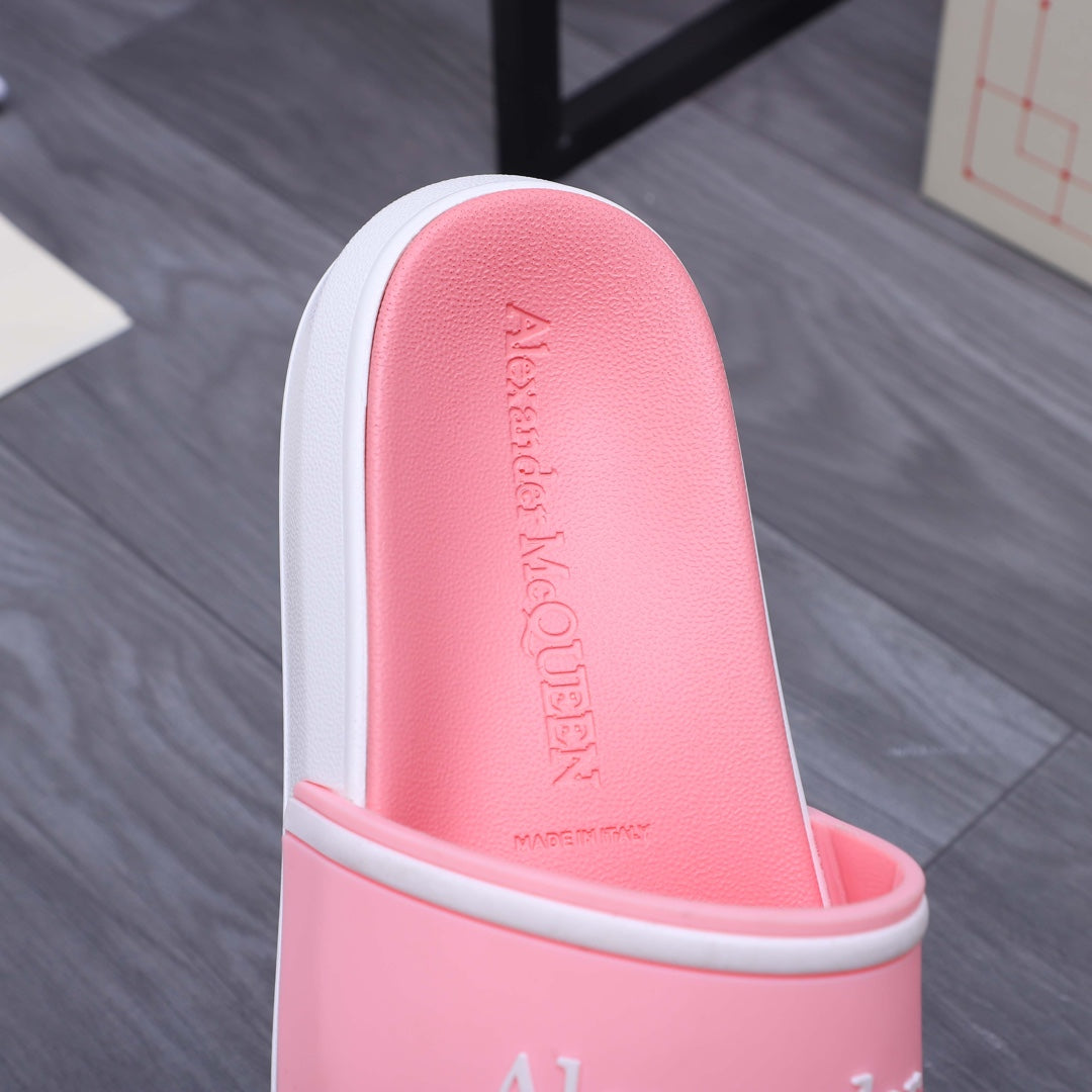 Pink slide sandal footbed with embossed Alexander McQueen text, white sidewall