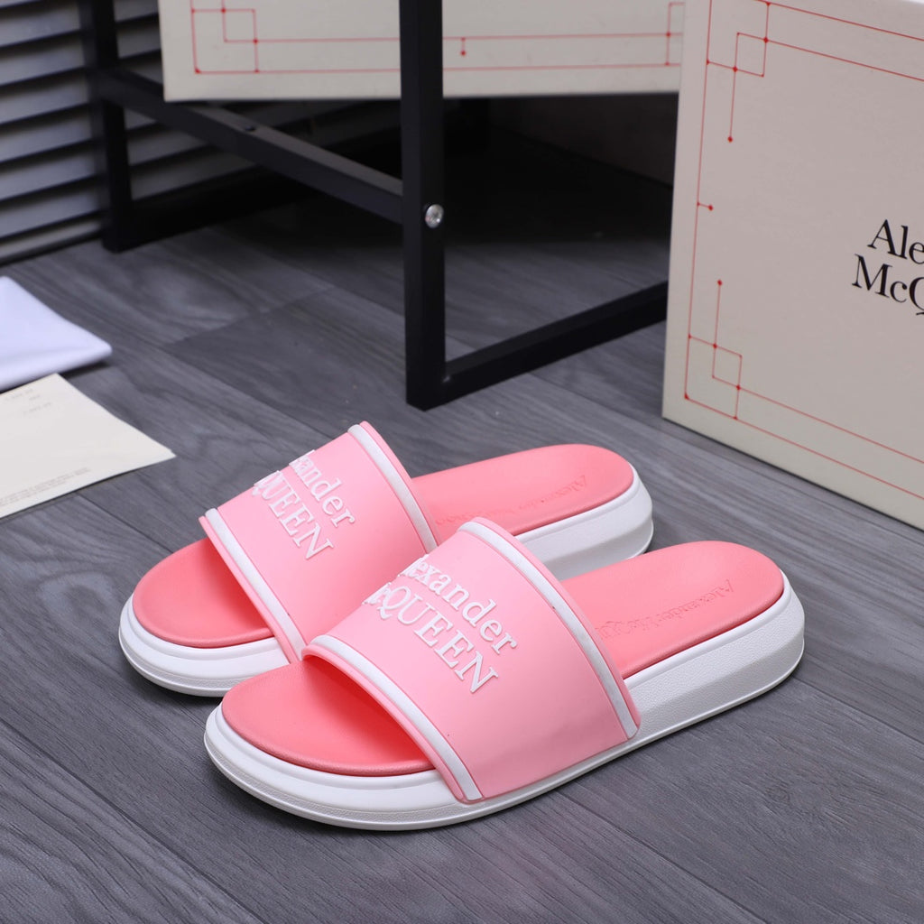 Pink slide sandals with V-shaped strap and Alexander McQueen logo, flat white sole