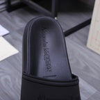 Alexander McQueen black slide sandal, embossed logo on footbed upper