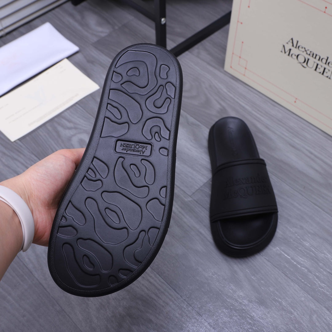 Alexander McQueen black slide sandal outsole, textured grip pattern visible