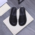 Alexander McQueen black slide sandals with logo-embossed strap and footbed