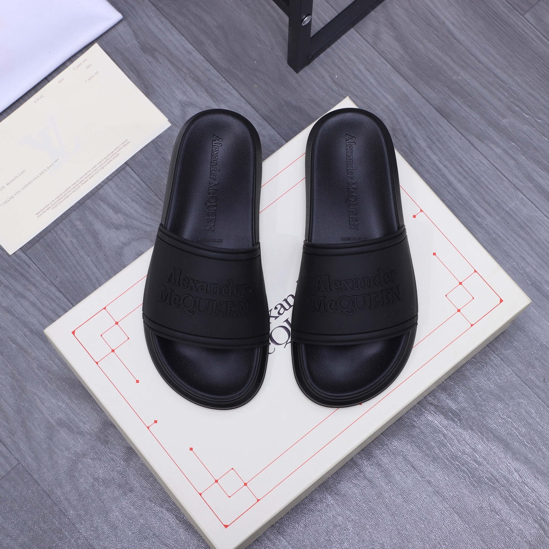 Alexander McQueen black slide sandals with logo-embossed strap and footbed