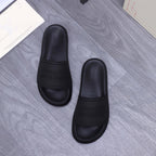 Alexander McQueen black slide sandals, two shoes shown with embossed logo details